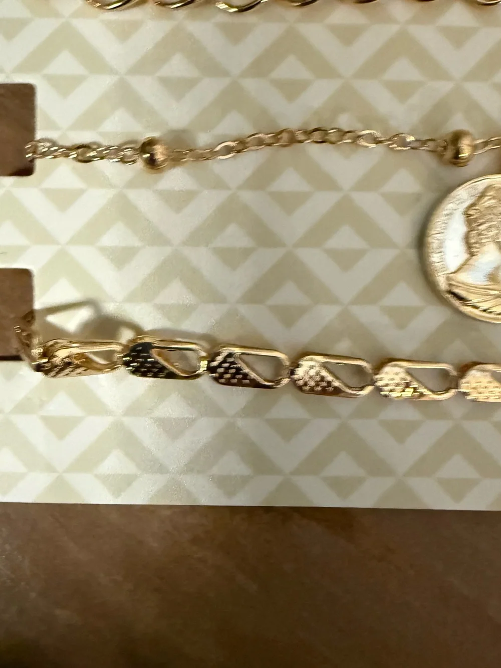 Set of 3 D’Bello packaged gold toned bracelets.